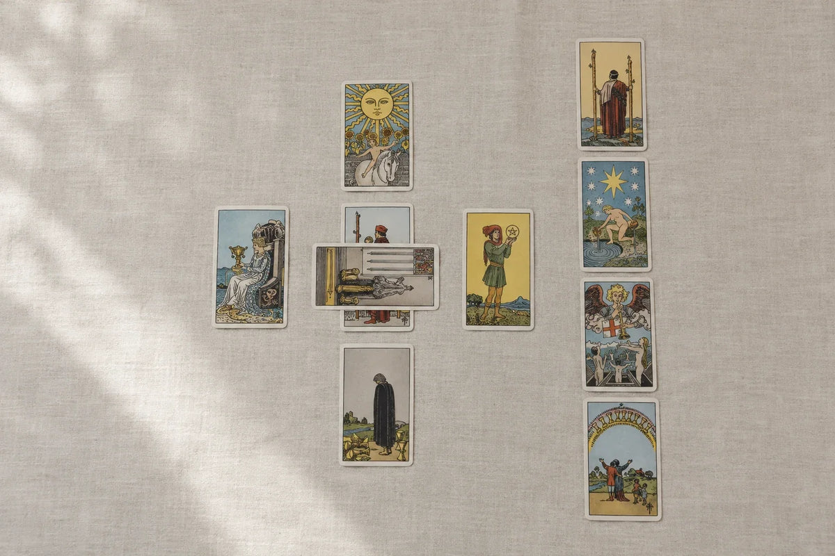 Ten tarot cards arranged in a Celtic Cross with a crossing center pair and four-card column.